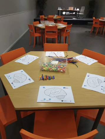 Brain Awareness Week activity table with coloring pages and craft materials